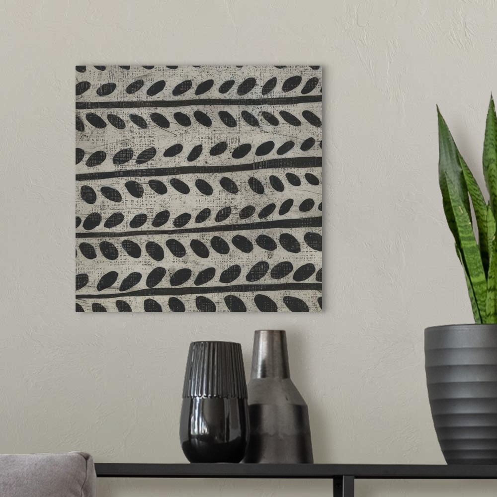 A modern room featuring This decorative artwork features a black and white pattern in a hand painted style with a distres...