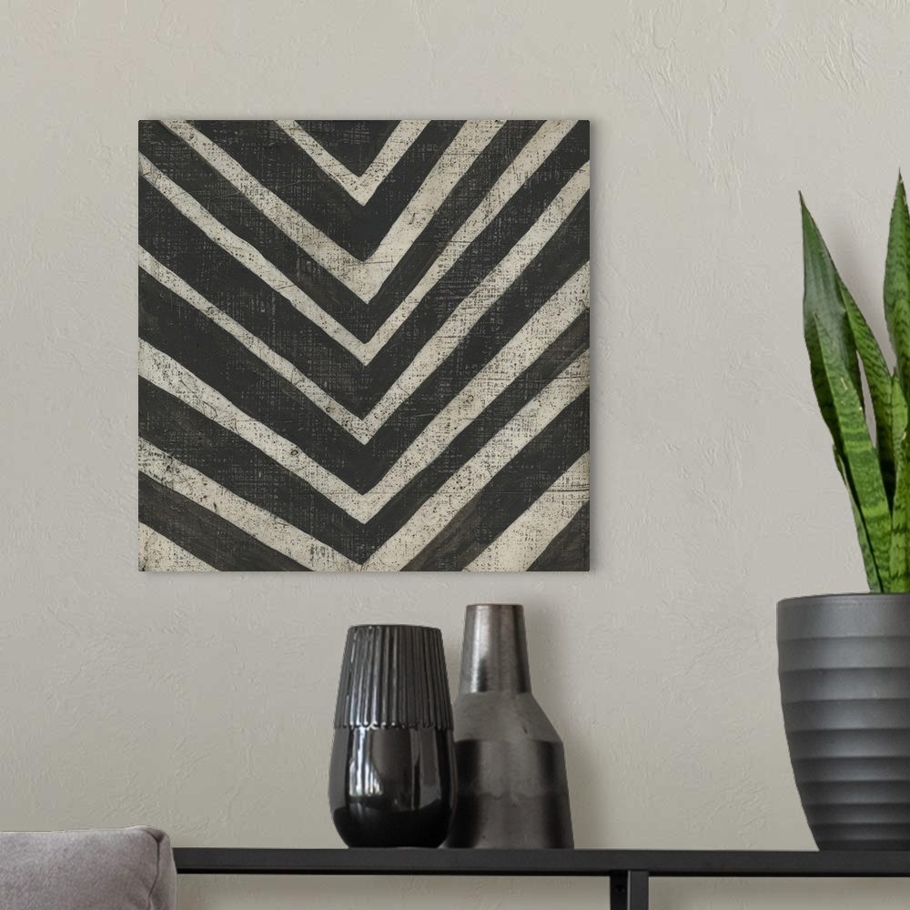 A modern room featuring This decorative artwork features a black and white pattern in a hand painted style with a distres...
