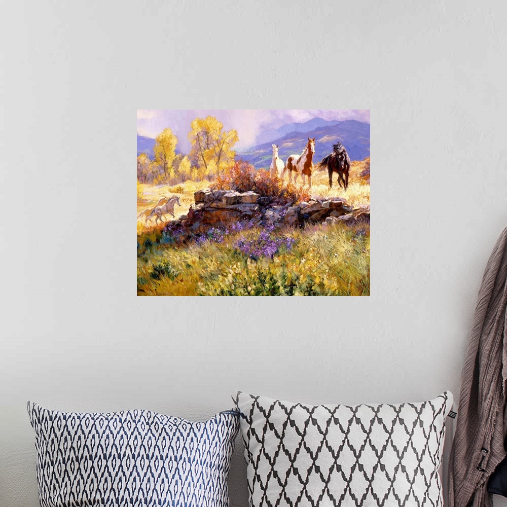 A bohemian room featuring Contemporary colorful painting of a herd of horses standing in a rugged landscape, with a mountai...