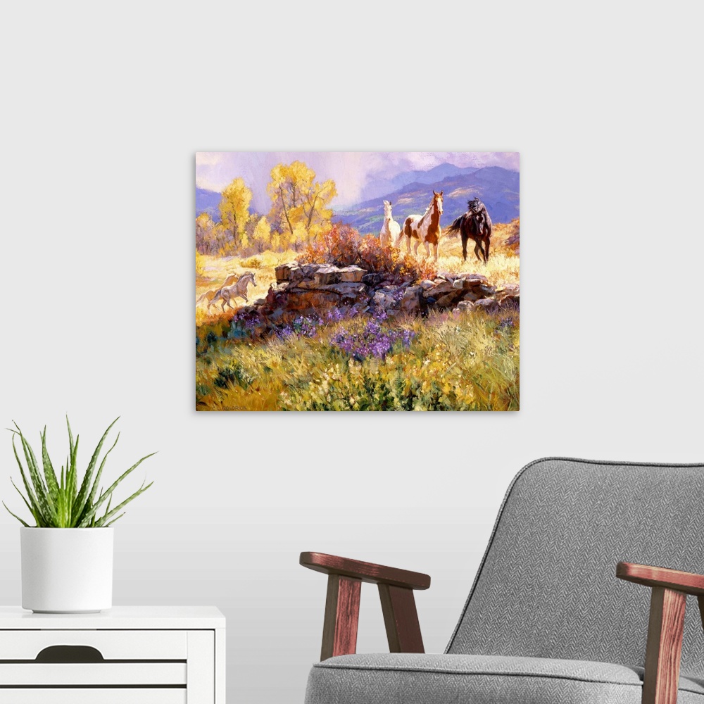 A modern room featuring Contemporary colorful painting of a herd of horses standing in a rugged landscape, with a mountai...