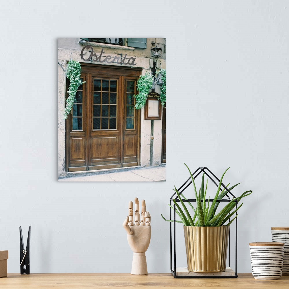 A bohemian room featuring A photograph of the doors of a rustic mediterranean cafe.