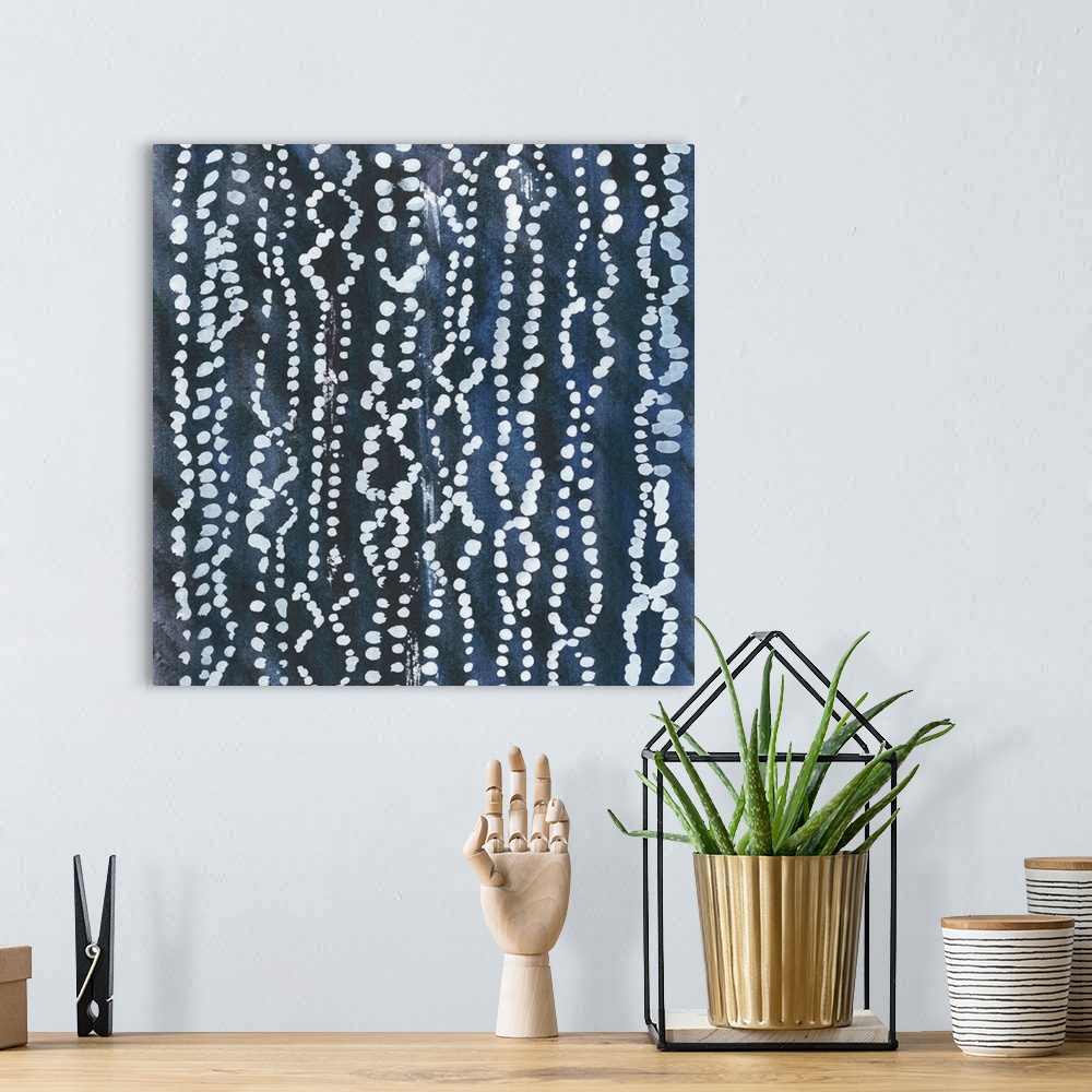 A bohemian room featuring Abstract art with a dark blue background and circular designs in lines on top in gray.