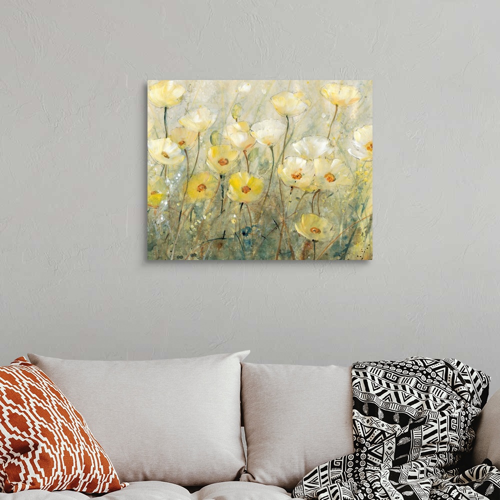 A bohemian room featuring Contemporary painting of several yellow flowers growing in a field.
