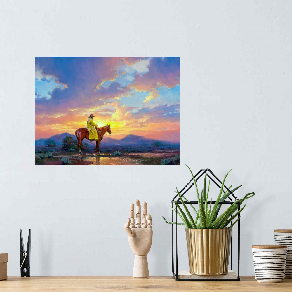 A bohemian room featuring Painting of man in trench coat on horse in desert at sunset.  There are mountains in the distance.