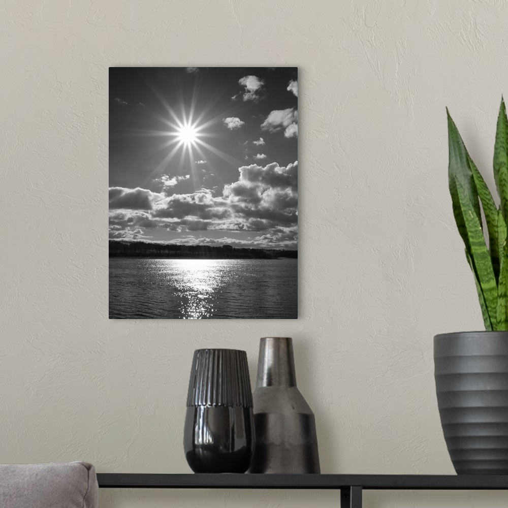 A modern room featuring Fine art photo of the bright sun shining over the sea.