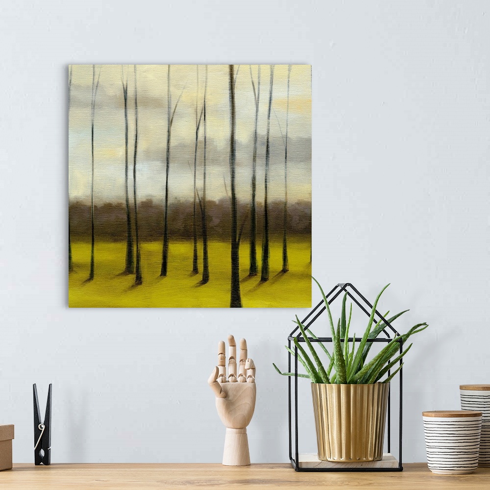 A bohemian room featuring Contemporary painting of meadow filled with bare trees under a dark cloudy sky.