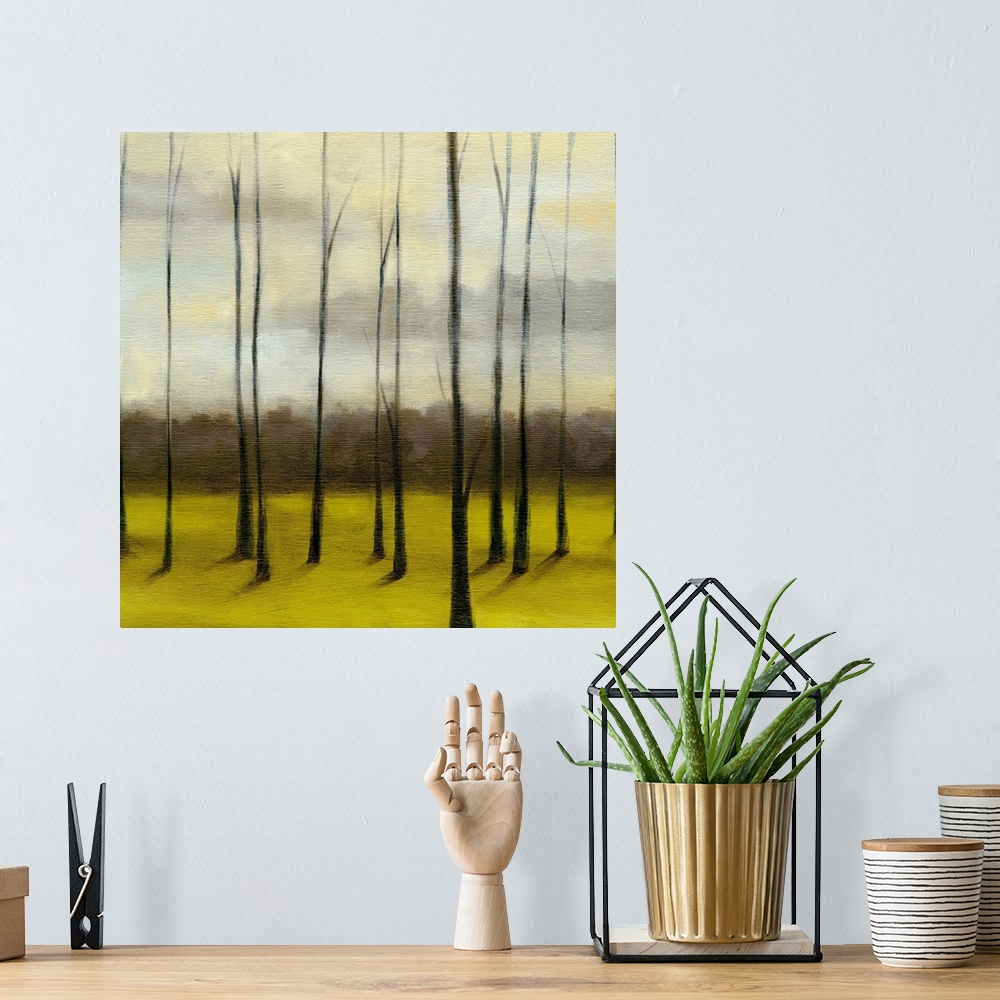 A bohemian room featuring Contemporary painting of meadow filled with bare trees under a dark cloudy sky.
