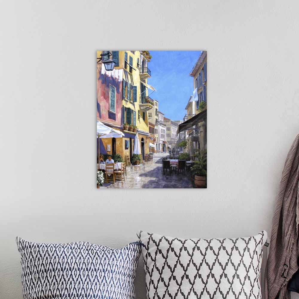 A bohemian room featuring Contemporary artwork of a street scene in the Italian town of Portofino.