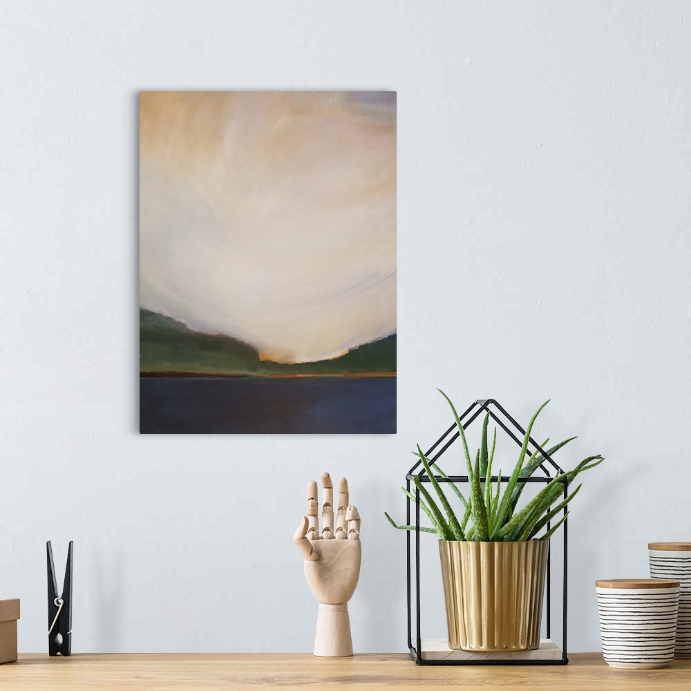 A bohemian room featuring Vertical landscape painting of a lake with greenery on the horizon and a warm sunset above.