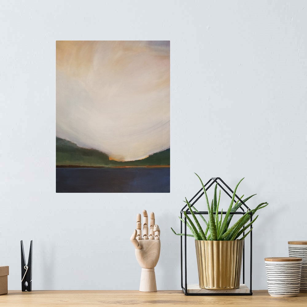 A bohemian room featuring Vertical landscape painting of a lake with greenery on the horizon and a warm sunset above.