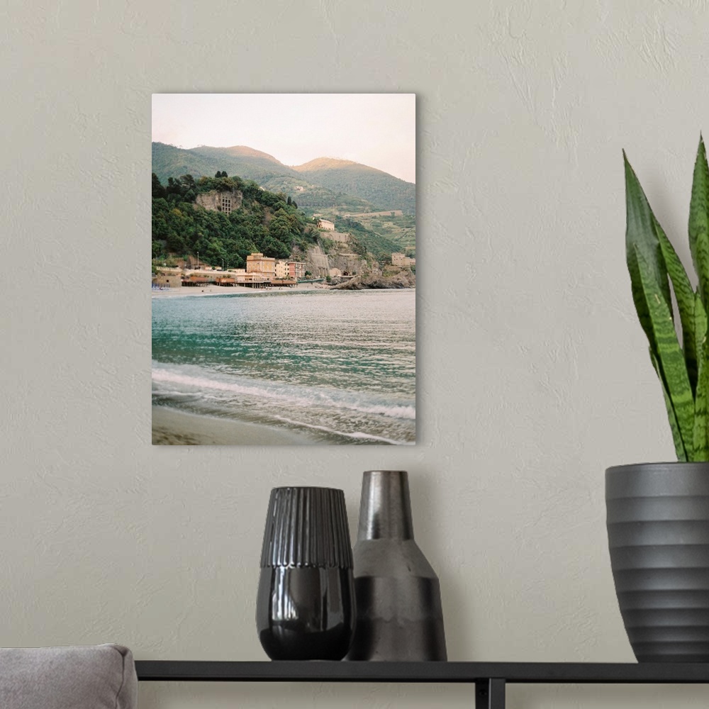 A modern room featuring Photograph of the water in front of a sunlit town, Cinque Terre, Italy.