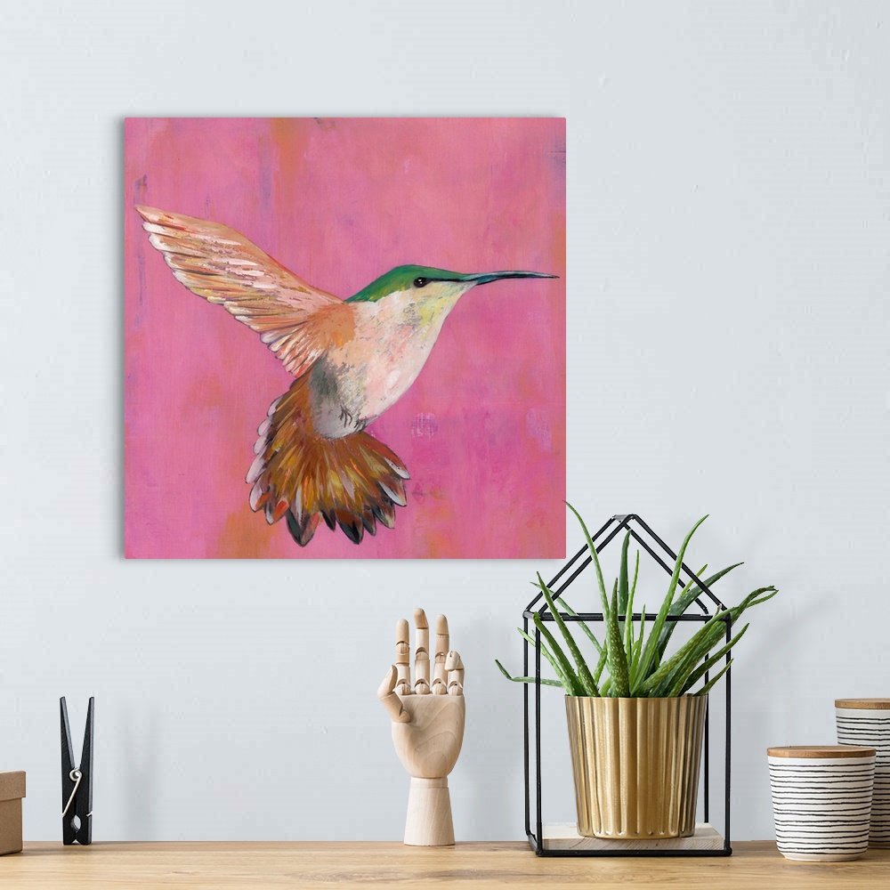 A bohemian room featuring Contemporary painting of a hummingbird hovering against a pink background.