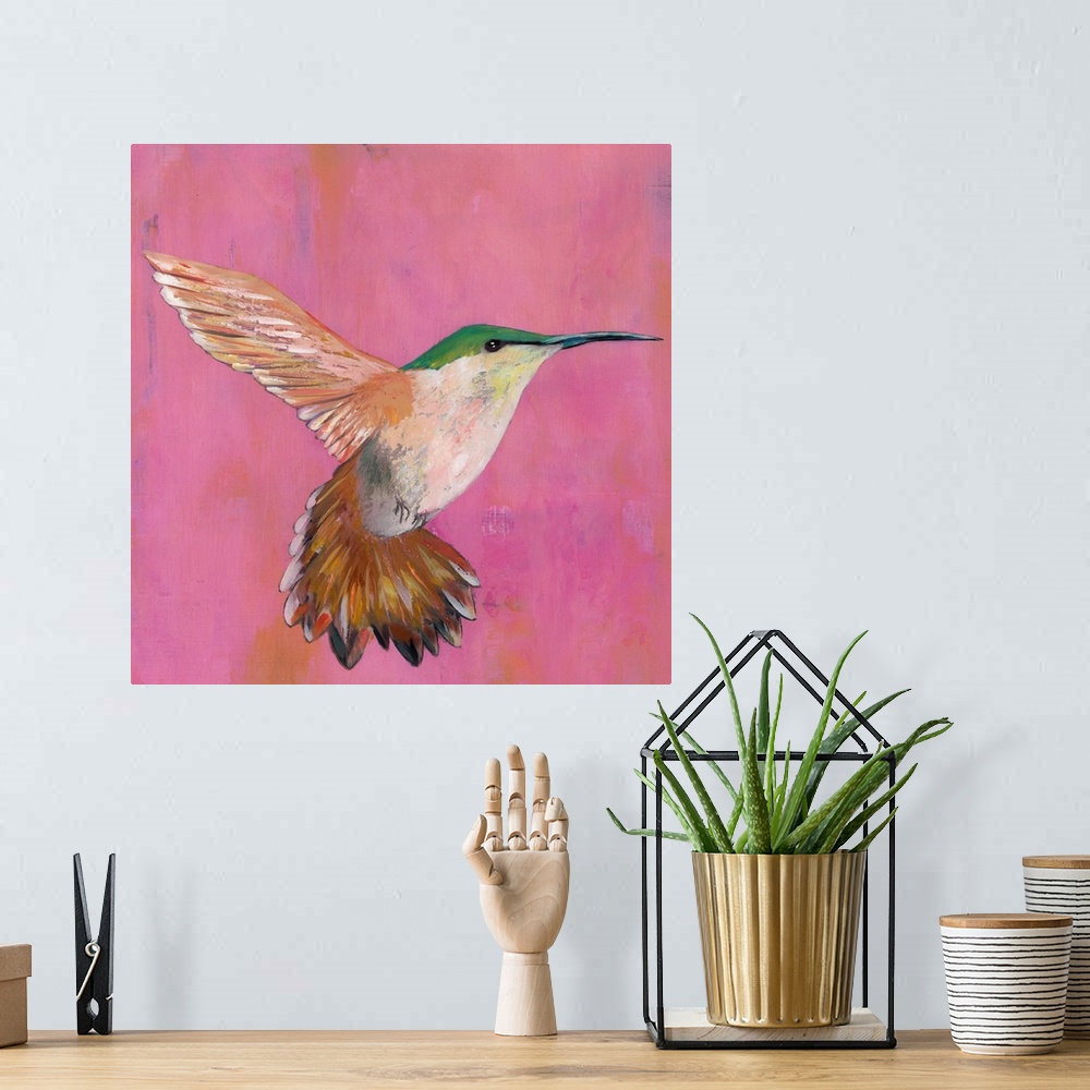 A bohemian room featuring Contemporary painting of a hummingbird hovering against a pink background.