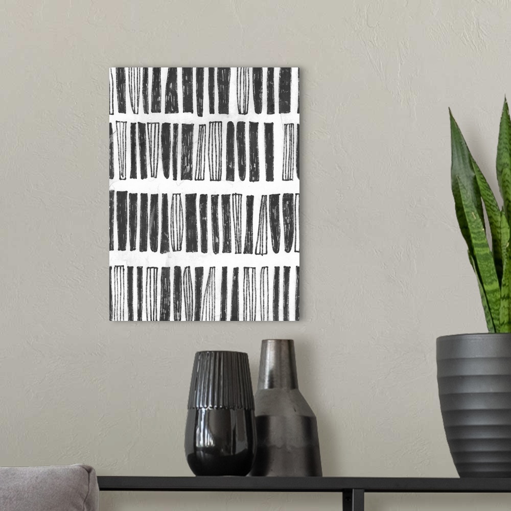 A modern room featuring Black and white drawing of striped and solid vertical blocks.
