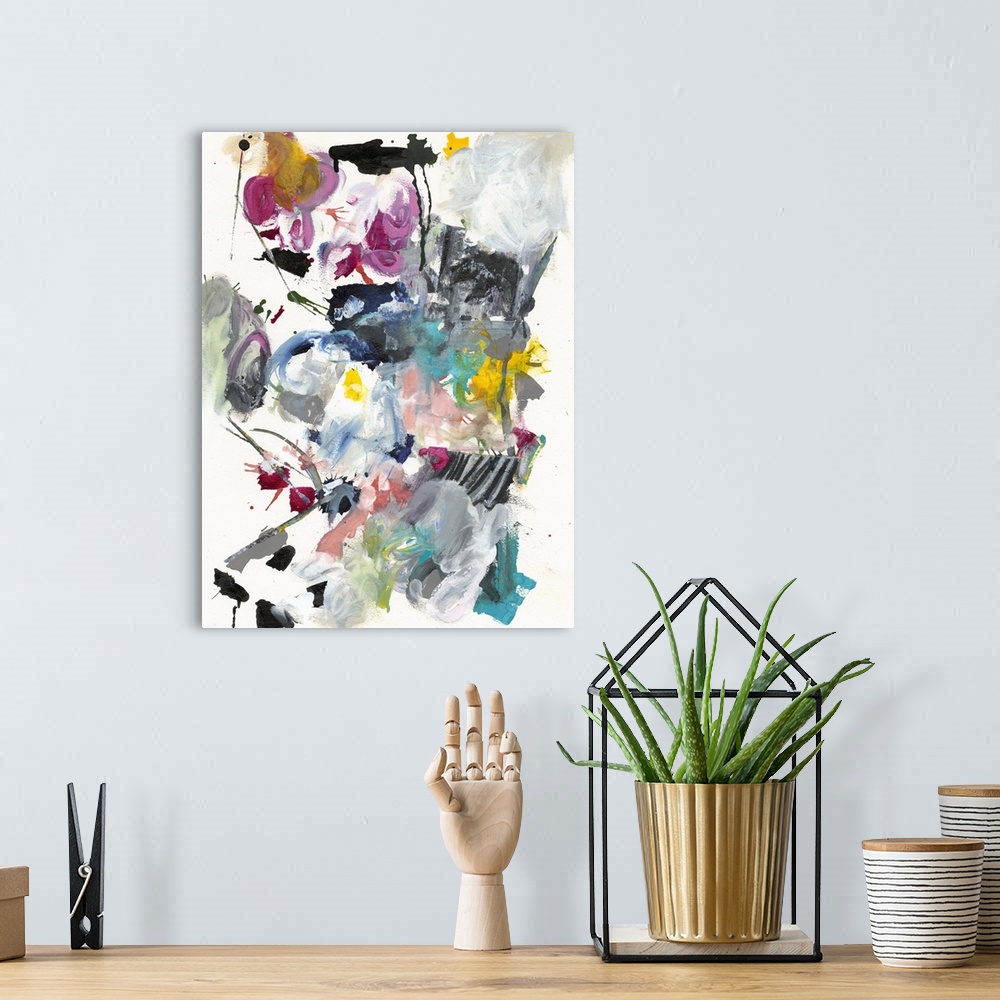 A bohemian room featuring Abstract painting in wild splashes and splatters of pink, teal, yellow, and black.