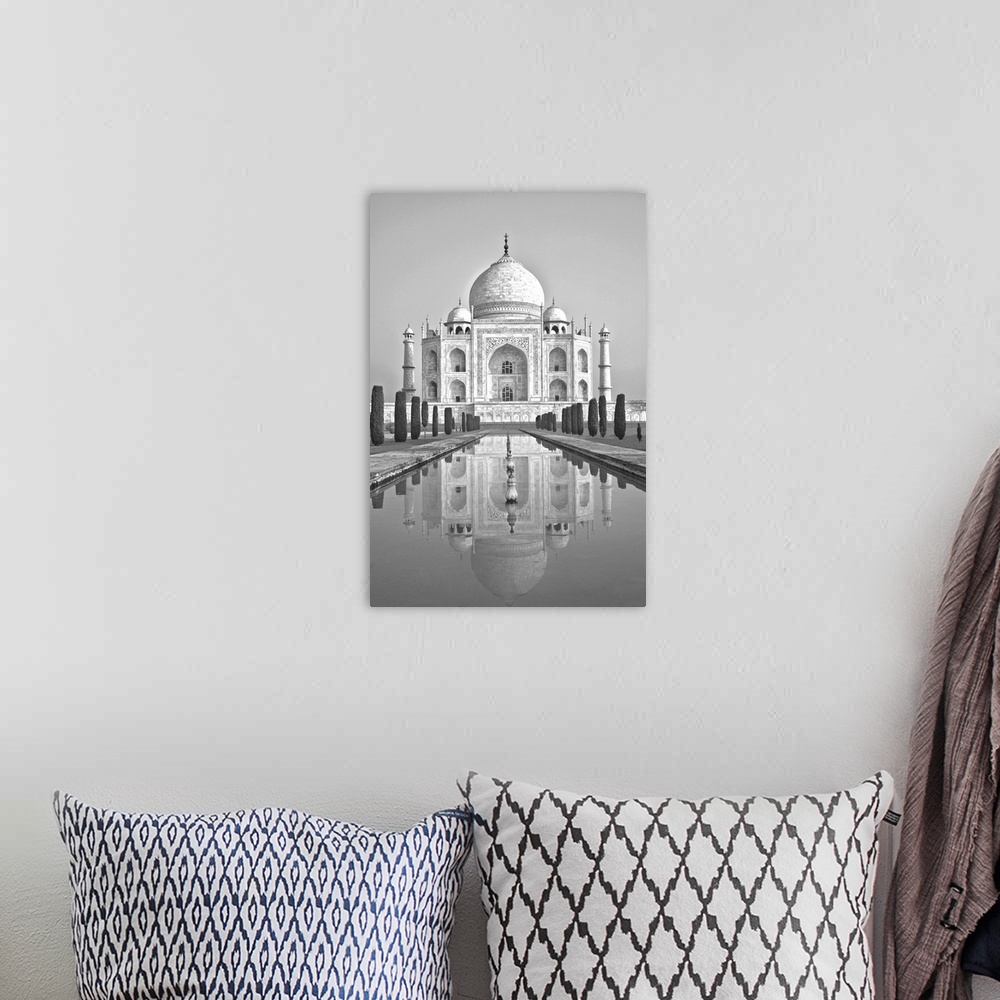 A bohemian room featuring Black and white image of the Taj Mahal reflected in the pool below in Agra, India.