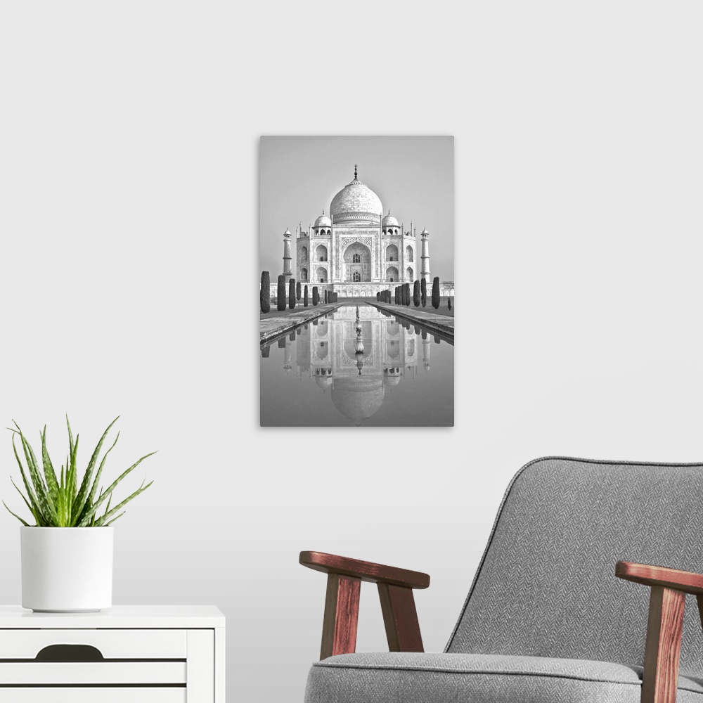 A modern room featuring Black and white image of the Taj Mahal reflected in the pool below in Agra, India.
