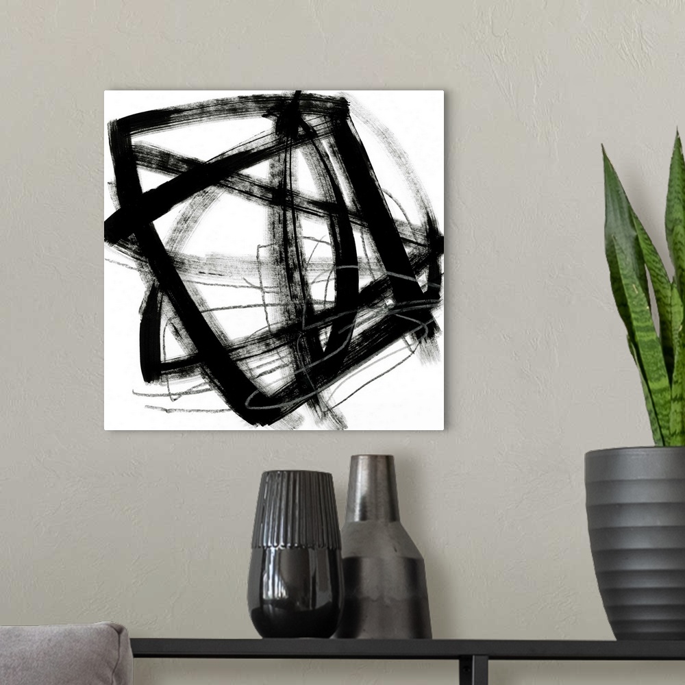 A modern room featuring Contemporary abstract painting using bold black contrasting against a stark white background.