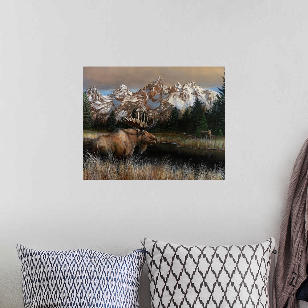 A bohemian room featuring Painting of a moose standing in tall grass next to a river with a rugged mountain range in the ba...