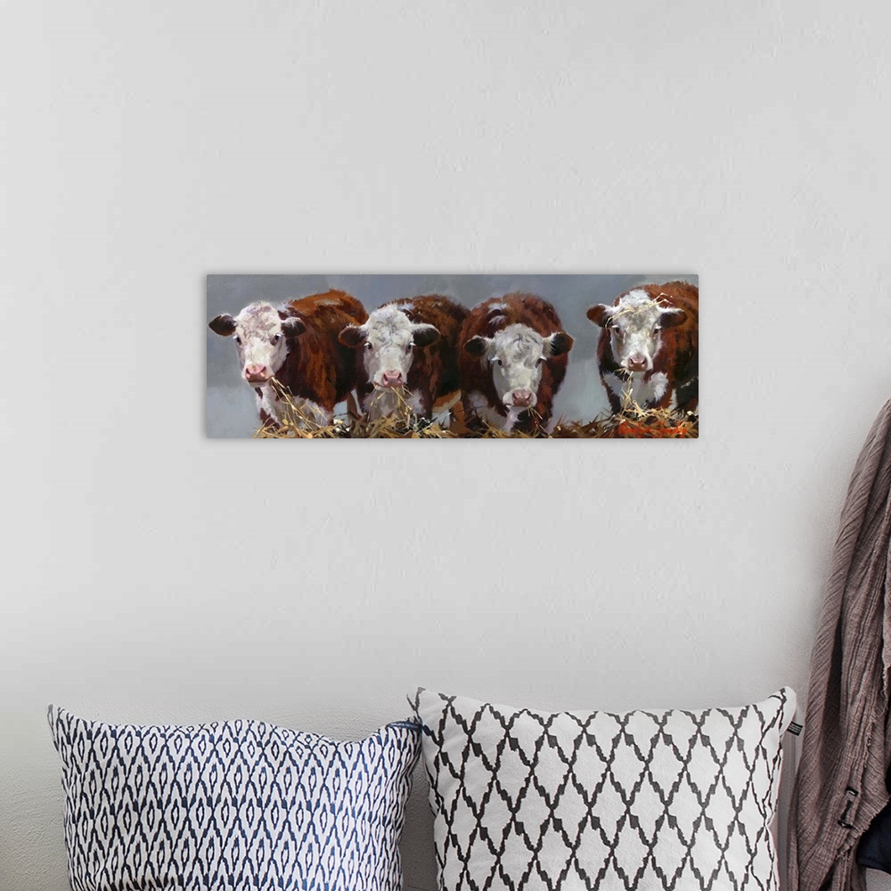 A bohemian room featuring Contemporary painting of four cows eating hay.