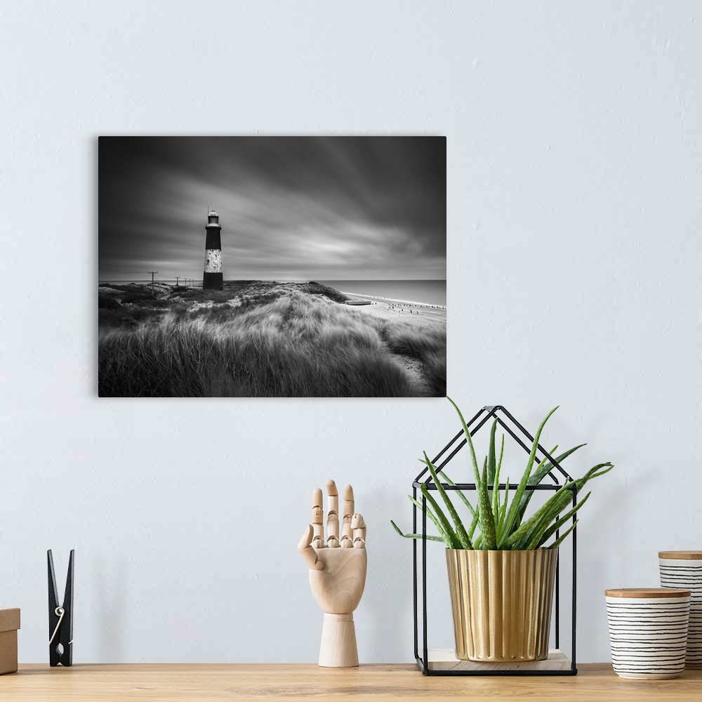 A bohemian room featuring Fine art photo of a striped lighthouse on the coast near grassy dunes.