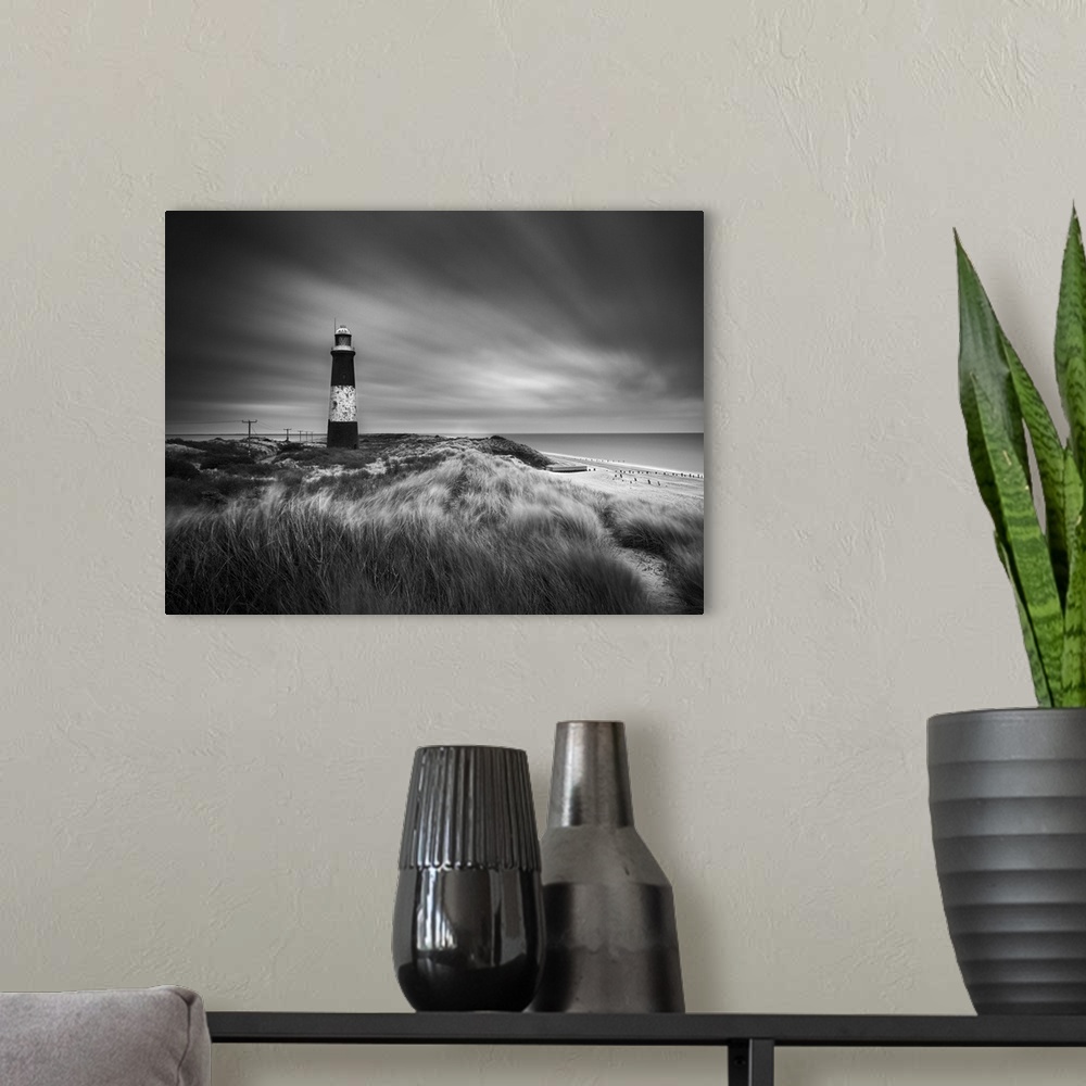 A modern room featuring Fine art photo of a striped lighthouse on the coast near grassy dunes.