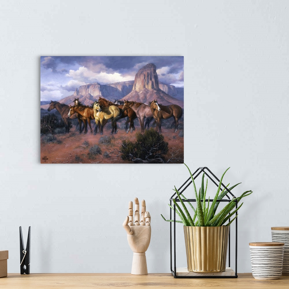 A bohemian room featuring Contemporary Western artwork of a herd of wild horses in a canyon standing alert and still.