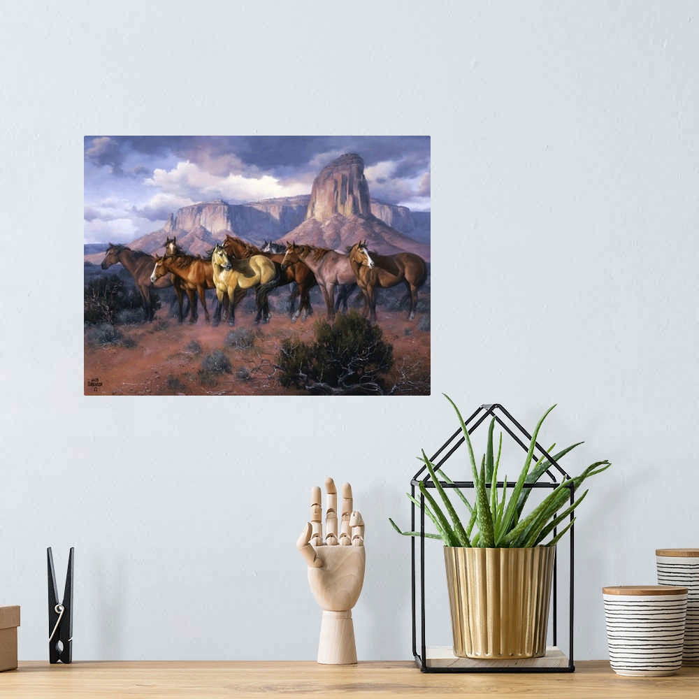 A bohemian room featuring Contemporary Western artwork of a herd of wild horses in a canyon standing alert and still.