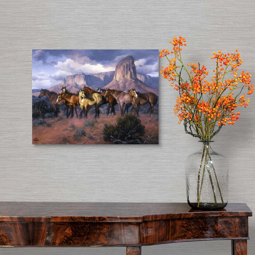 A traditional room featuring Contemporary Western artwork of a herd of wild horses in a canyon standing alert and still.