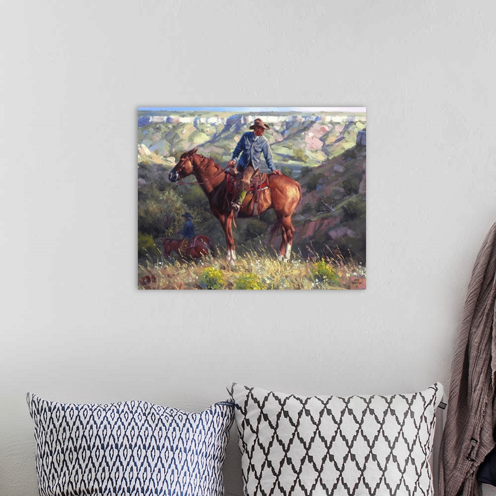 A bohemian room featuring Contemporary painting of a cowboy on a chestnut horse overlooking a western valley landscape.
