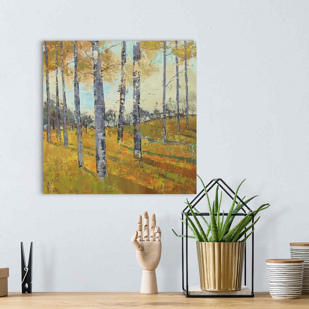 A bohemian room featuring Painting of trees casting shadows in a countryside clearing in autumn.