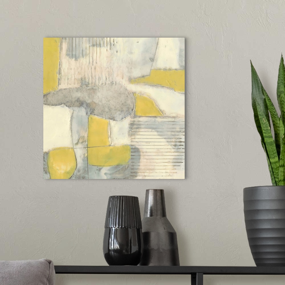 A modern room featuring Contemporary abstract painting using pale yellows and gray in geometric shapes.
