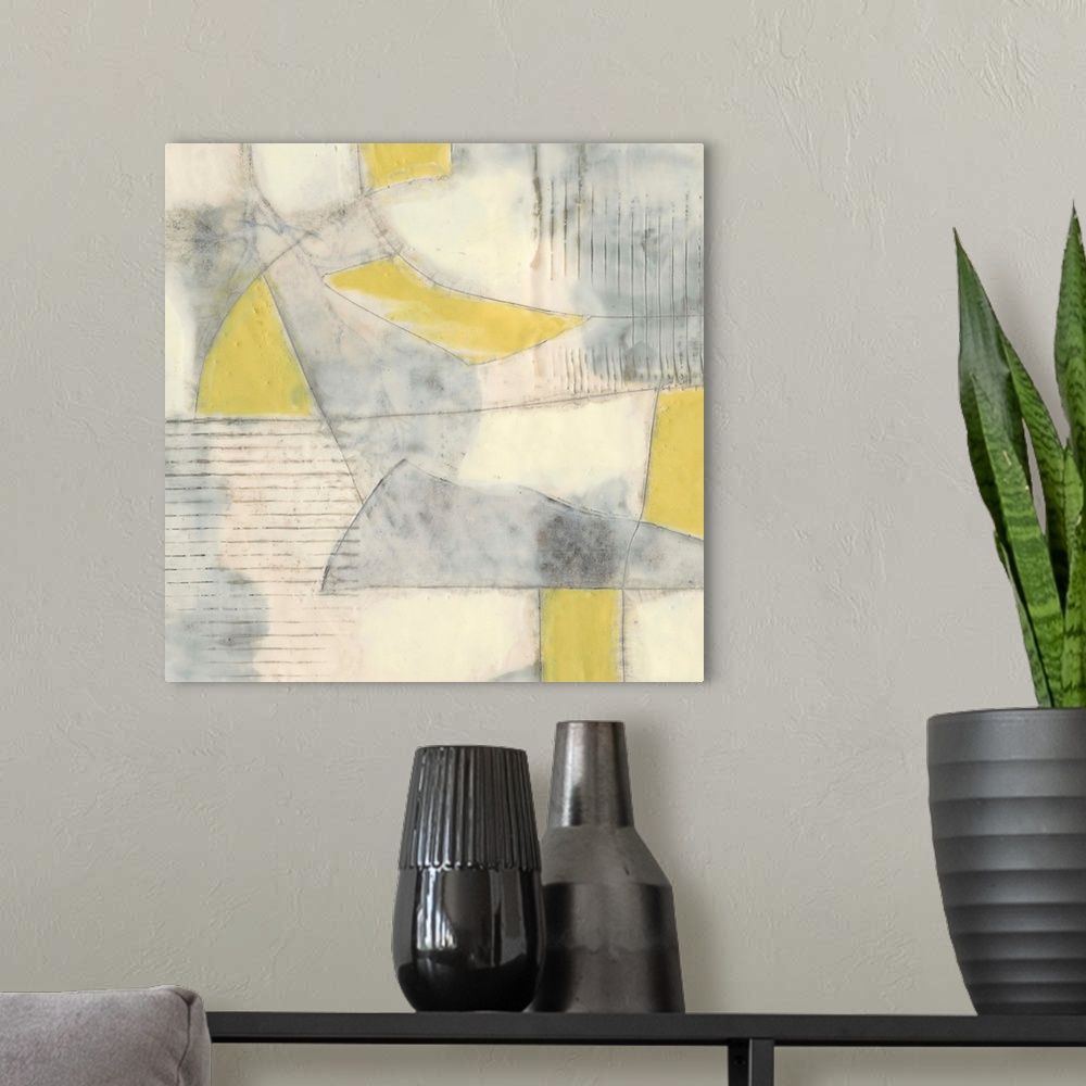 A modern room featuring Contemporary abstract painting using pale yellows and gray in geometric shapes.