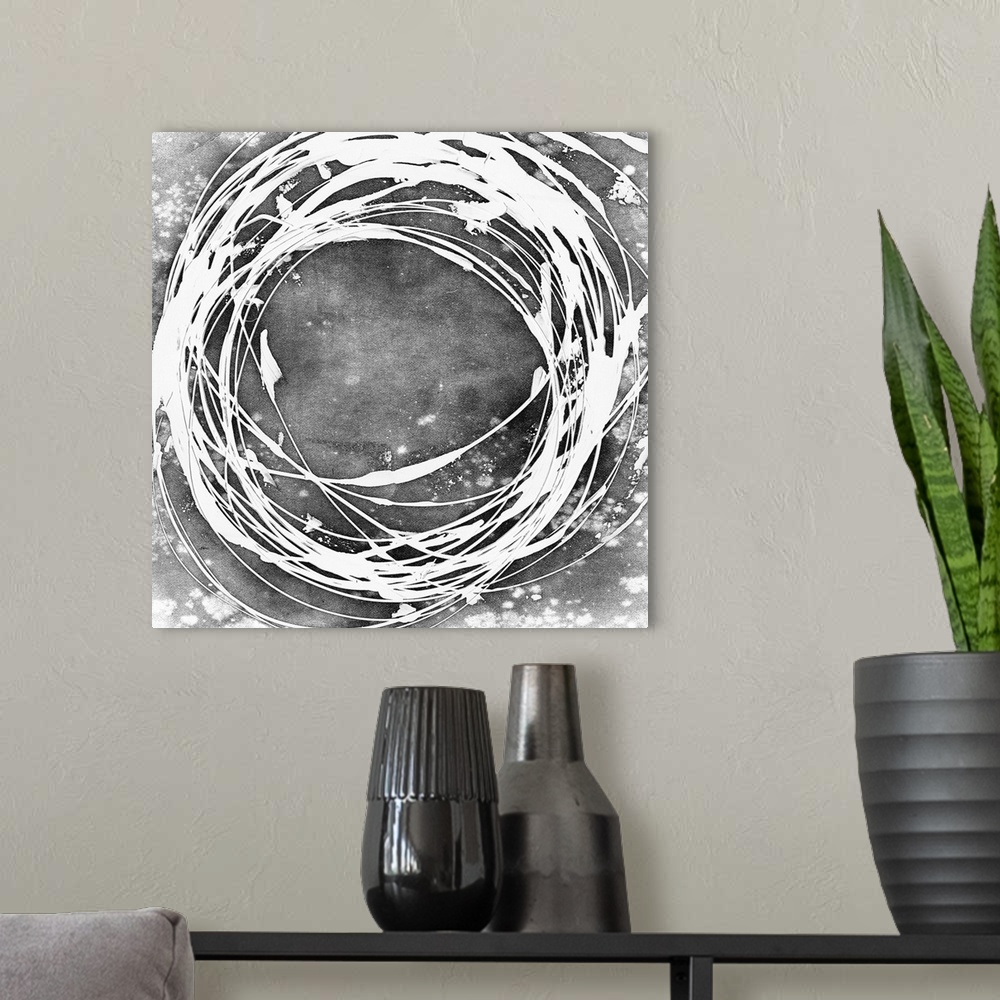 A modern room featuring Abstract painting in grey with a white circular shape.