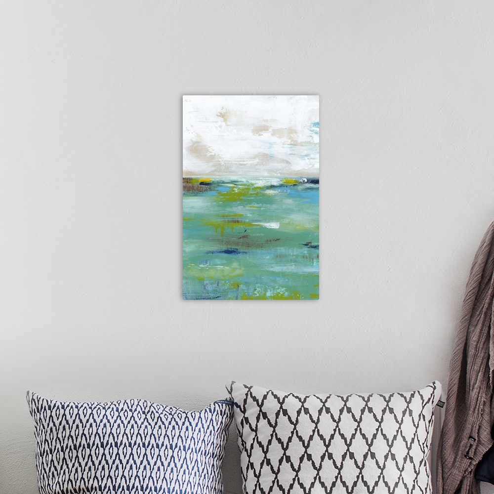 A bohemian room featuring Abstract painting resembling a body of water meeting the sky at the horizon.