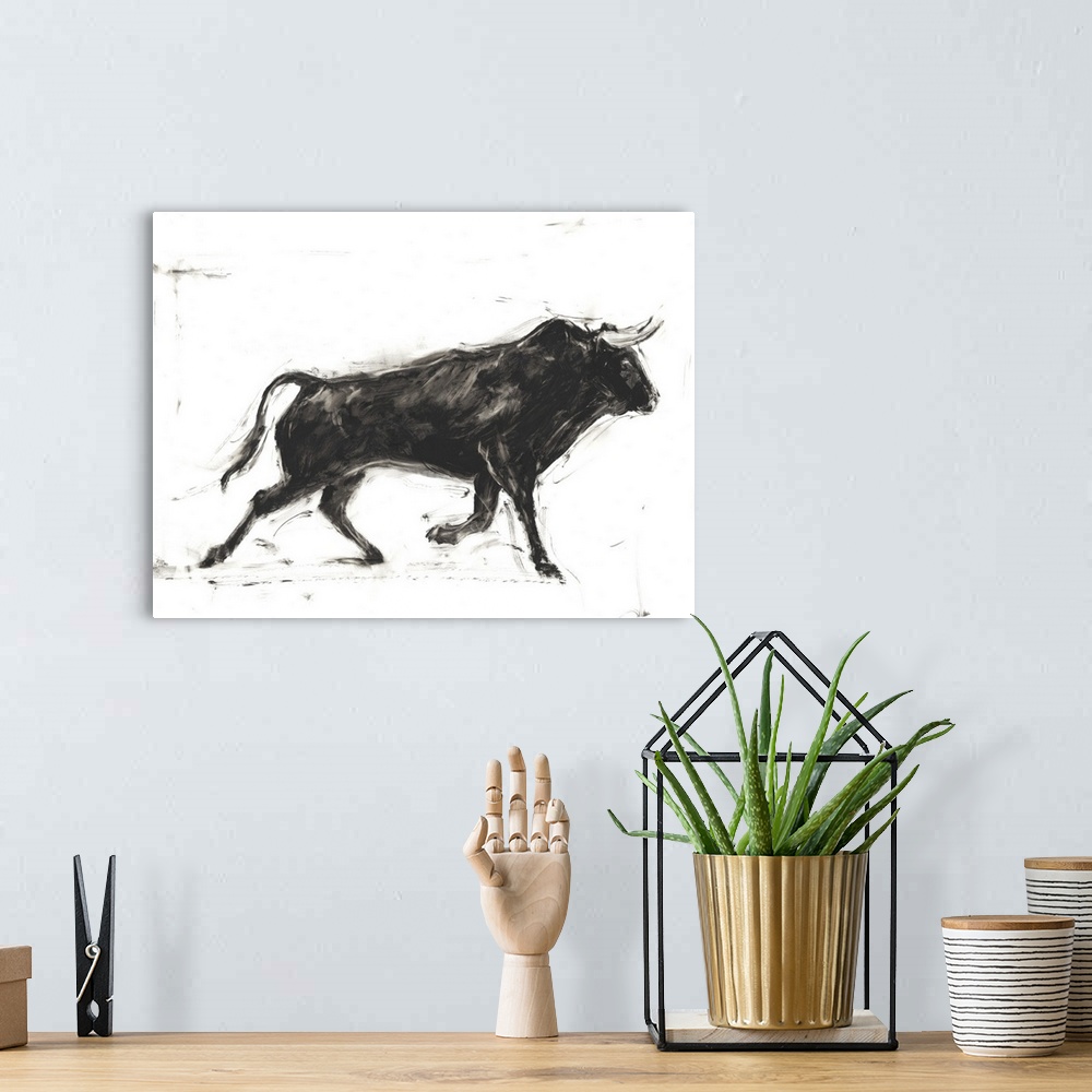 A bohemian room featuring Black and white painting of a Spanish bull in action.