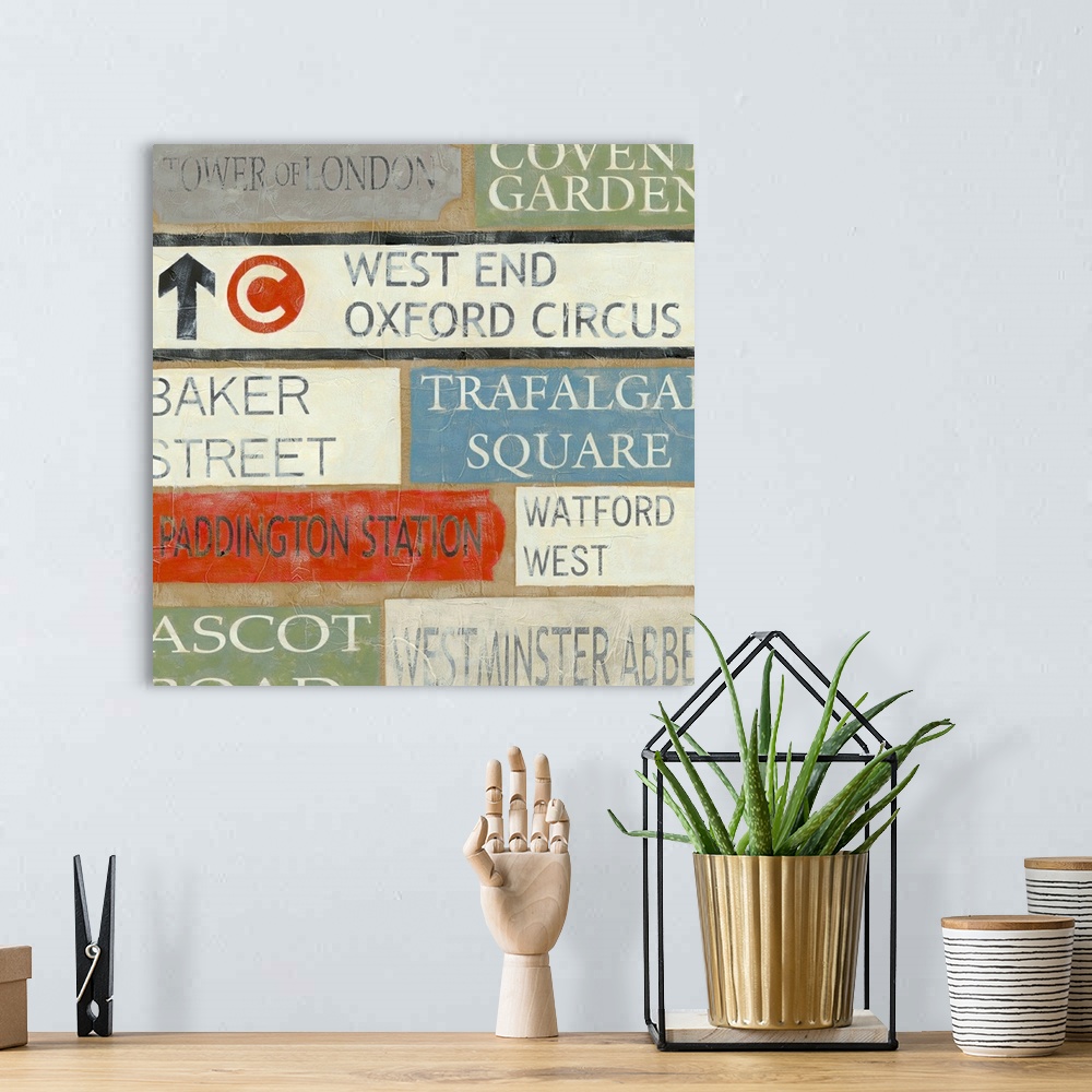 A bohemian room featuring Artwork of street signs arranged in a collage type pattern.  Some of signs are for Watford West, ...