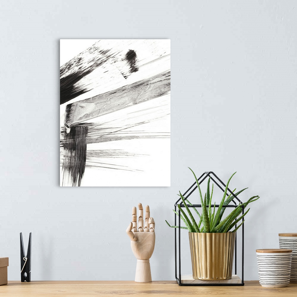 A bohemian room featuring Contemporary abstract painting of black and gray brushstrokes on a white background.
