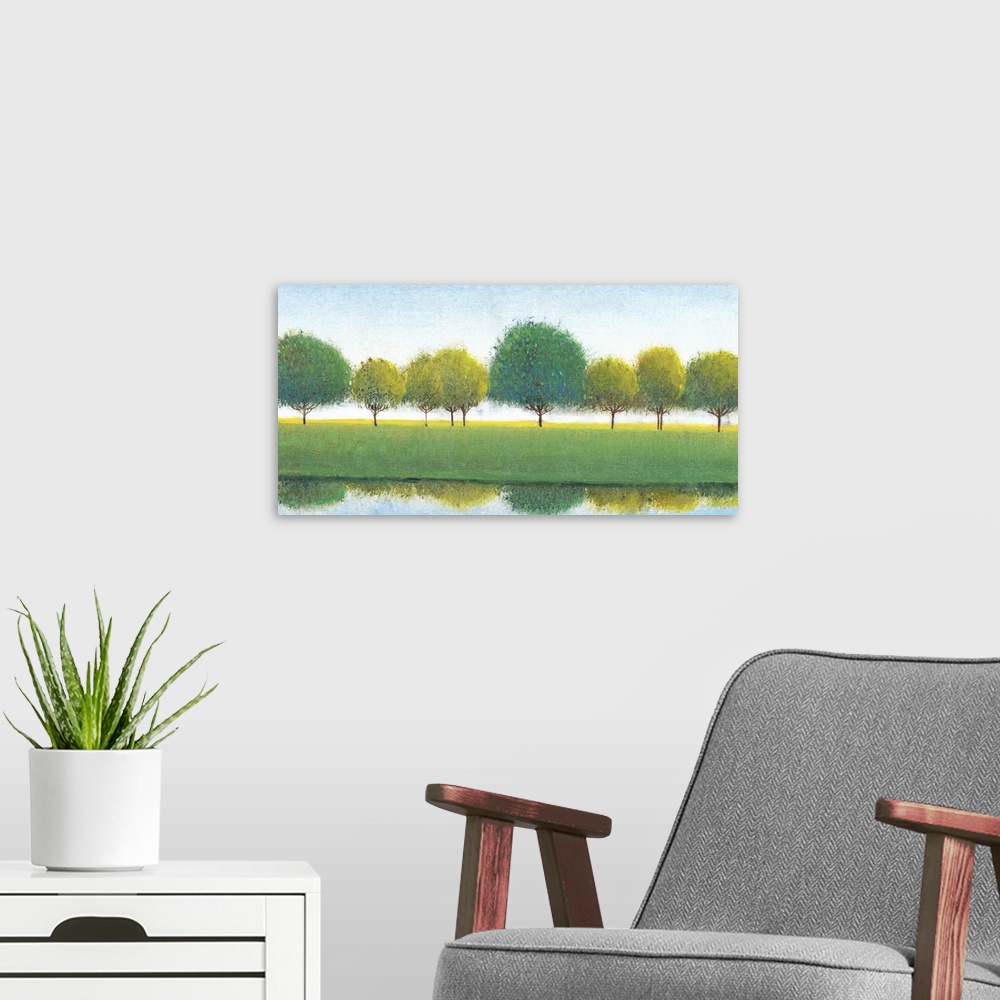 A modern room featuring Painting of a row of trees reflected in the river below.