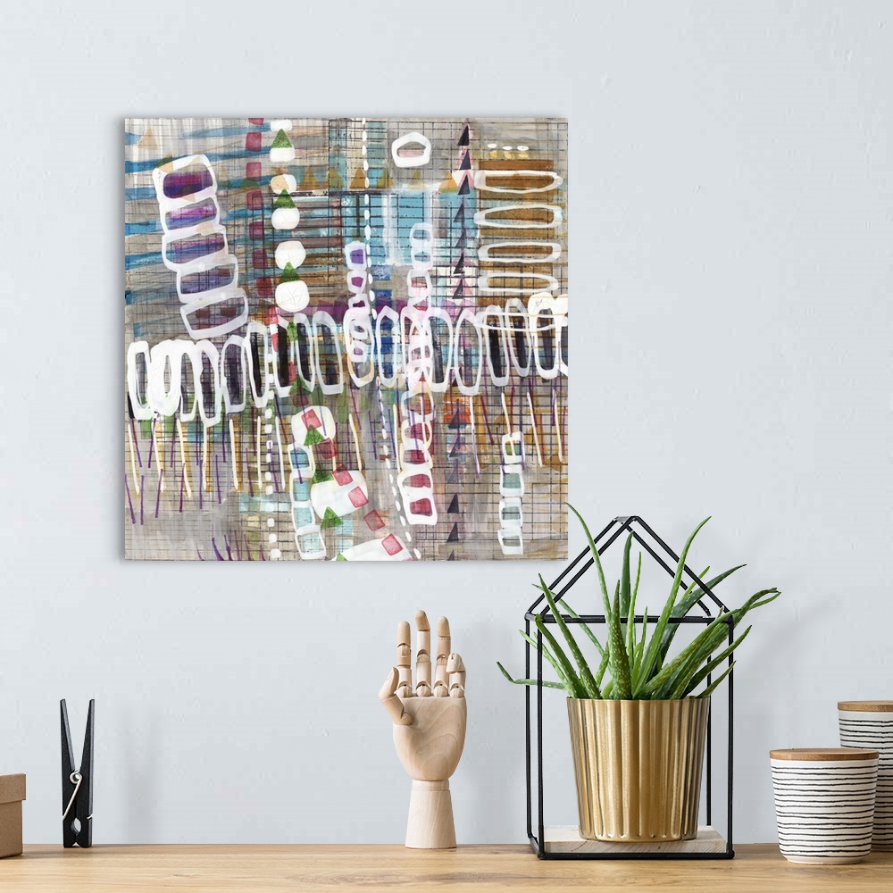 A bohemian room featuring Square abstract art with layered shapes and lines.