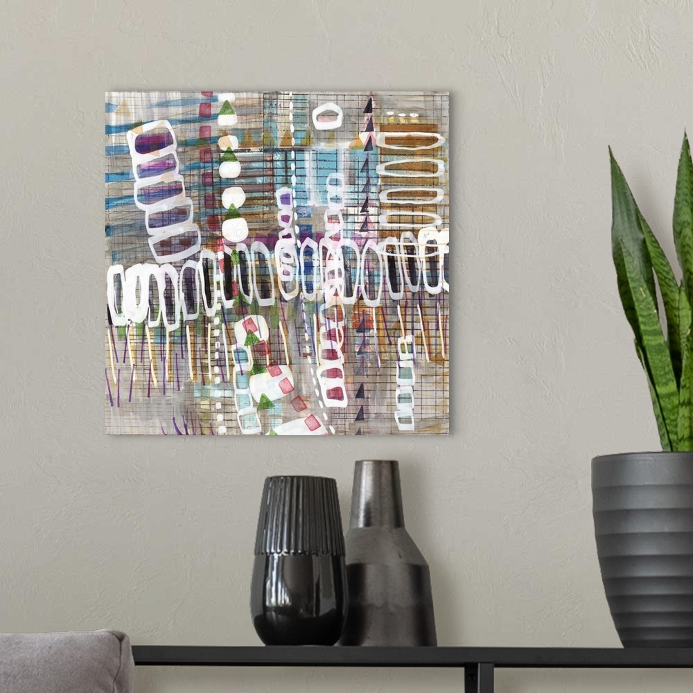 A modern room featuring Square abstract art with layered shapes and lines.
