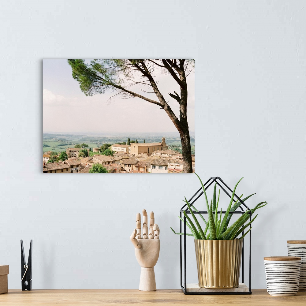 A bohemian room featuring Photograph of village in Tuscany with rolling landscape in the distance.
