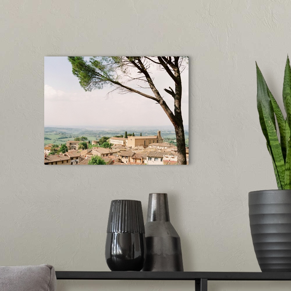 A modern room featuring Photograph of village in Tuscany with rolling landscape in the distance.