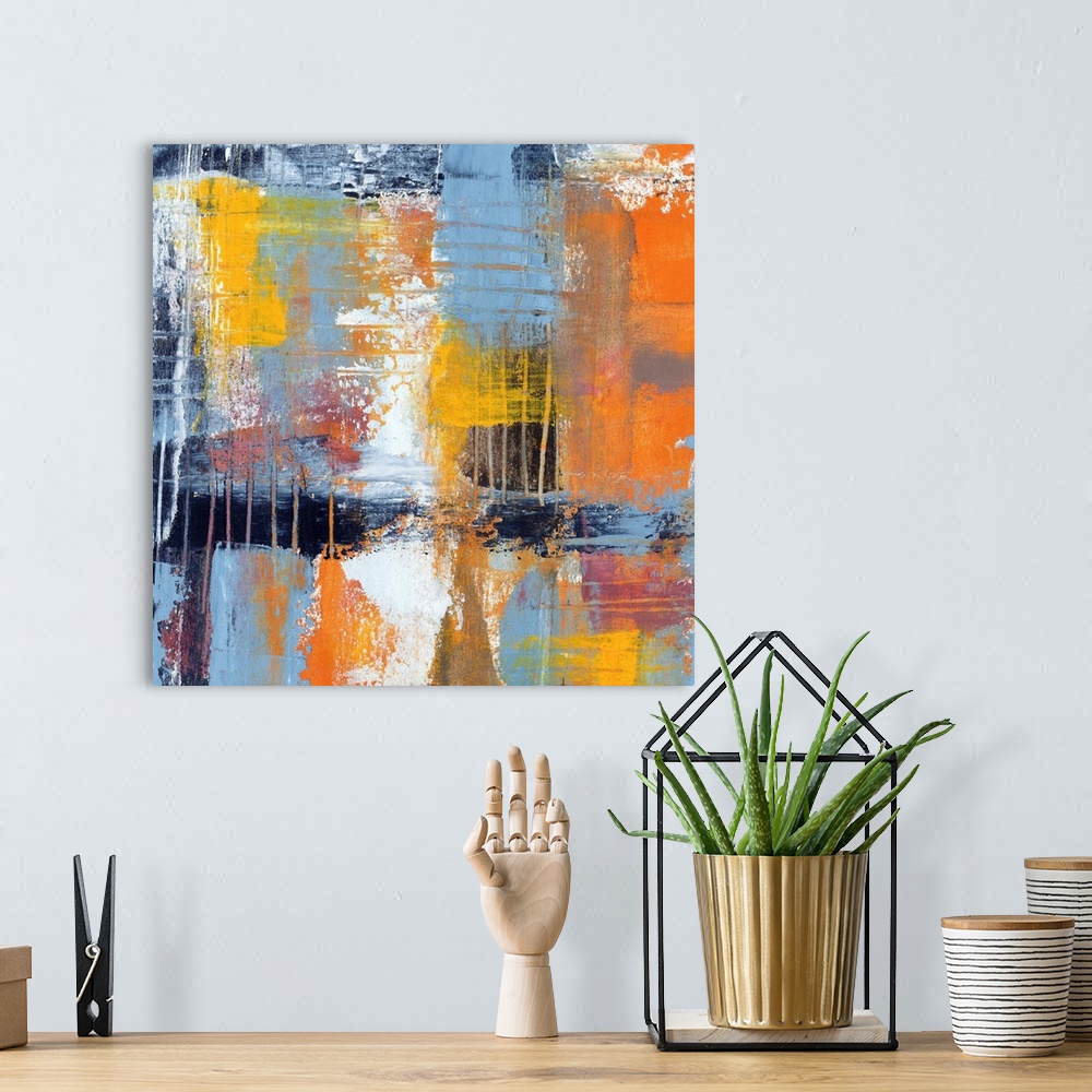 A bohemian room featuring Colorful contemporary abstract painting using muted blue orange and yellow tones.