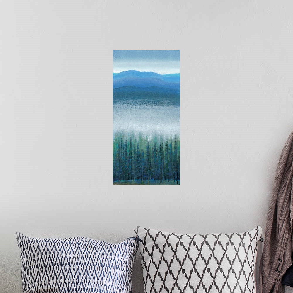 A bohemian room featuring Vertical painting of a mountain valley with dense fog over pine trees.