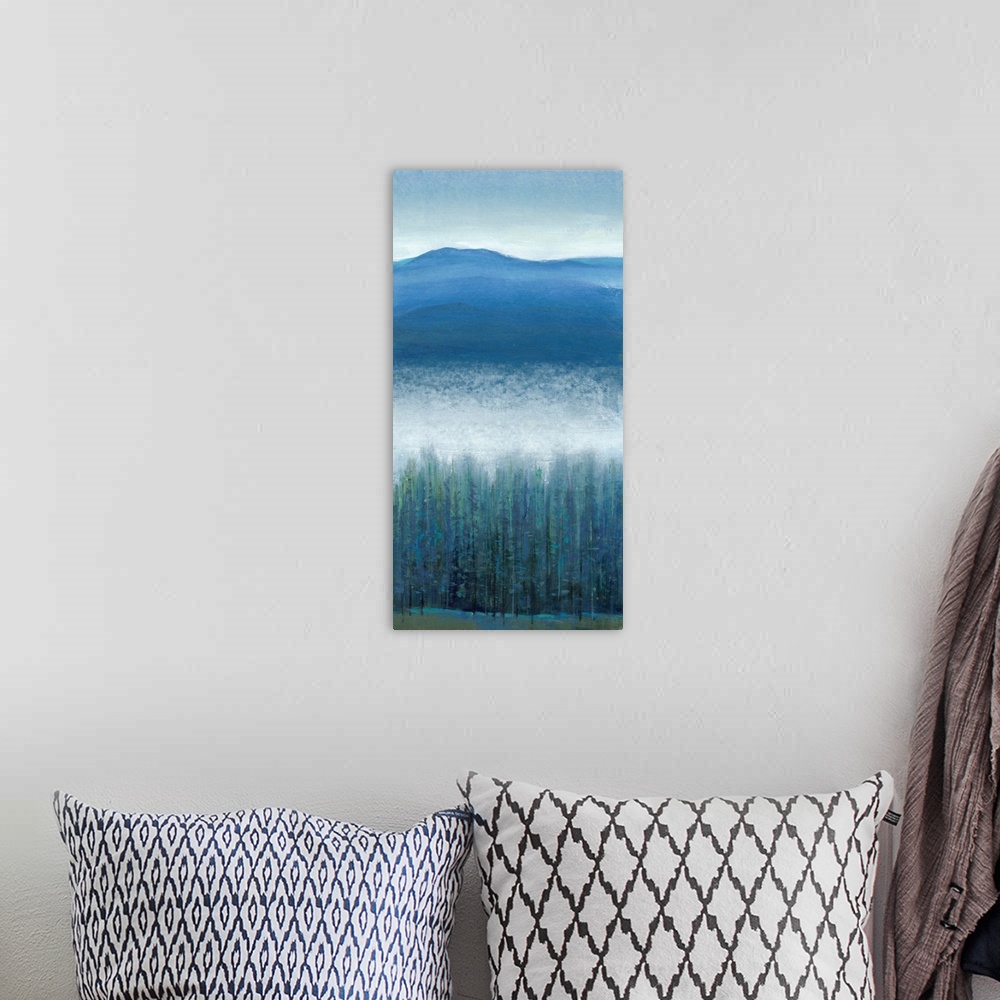 A bohemian room featuring Vertical painting of a mountain valley with dense fog over pine trees.