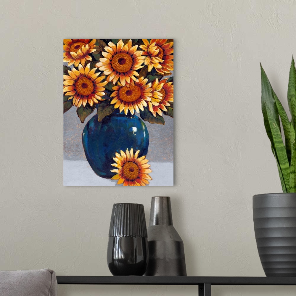 A modern room featuring A painting of vibrant yellow sunflowers sitting in a deep blue vase against a gray background.