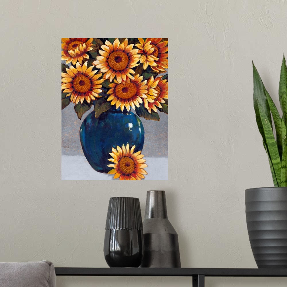 A modern room featuring A painting of vibrant yellow sunflowers sitting in a deep blue vase against a gray background.