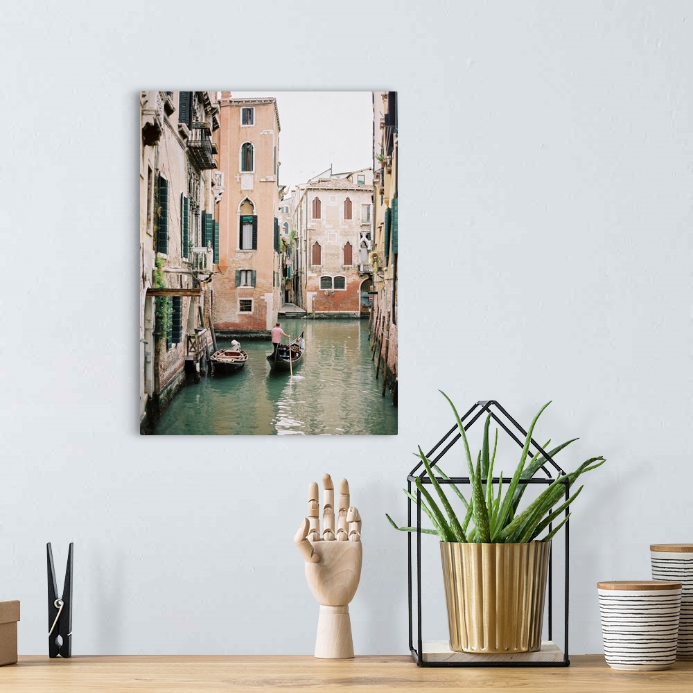 A bohemian room featuring Photograph of a gondolier steering his way through the canals of Venice, Italy.