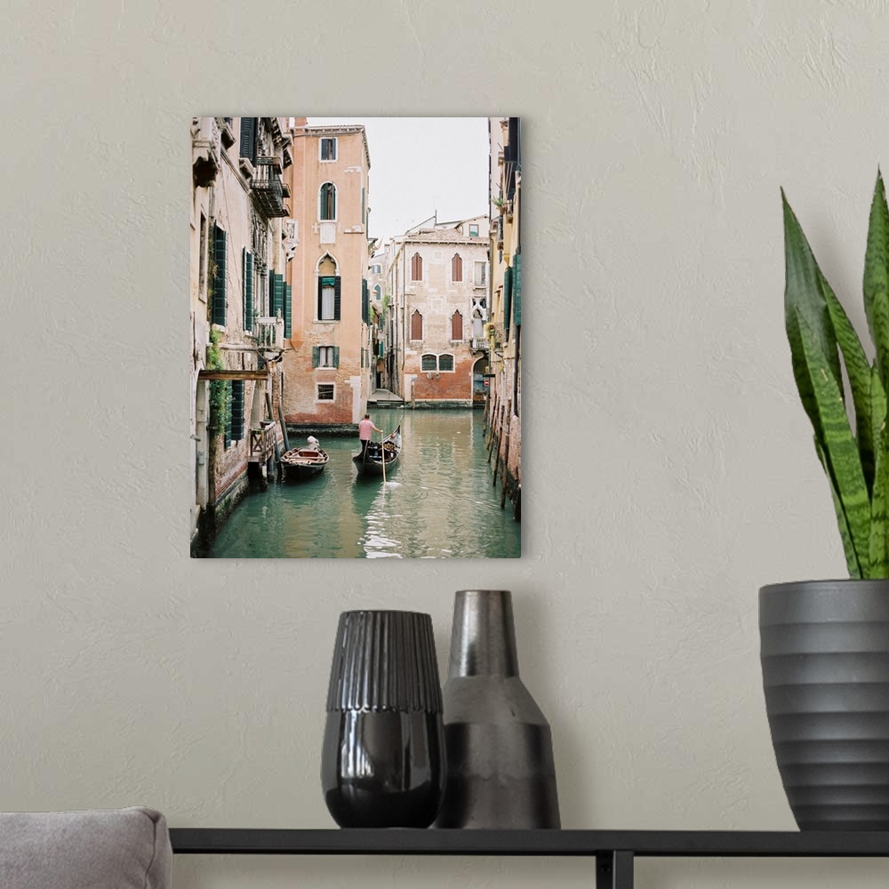 A modern room featuring Photograph of a gondolier steering his way through the canals of Venice, Italy.